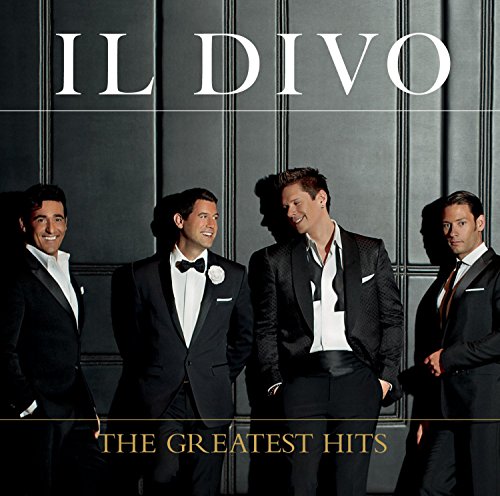 Four men in formal suits pose against a dark paneled wall, titled Il Divo.