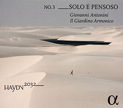 CD cover: lone figure walking across vast, white sand dunes.