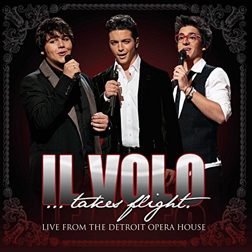 Il Volo trio performing live, with album title in red lettering.