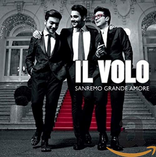 Il Volo album cover: three men in suits on a red carpet.
