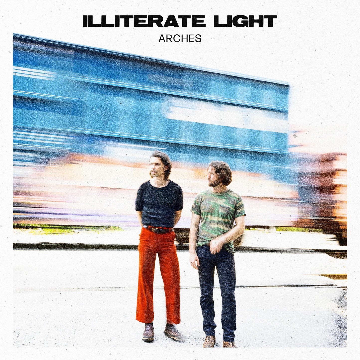 Album cover for Illiterate Light’s “Arches” featuring two men in front of blurred arches.