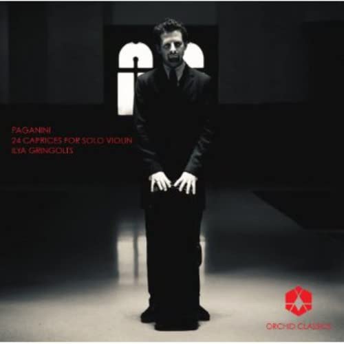 Ilya Gringolts standing in a dark room with Paganini 24 Caprices text on cover.