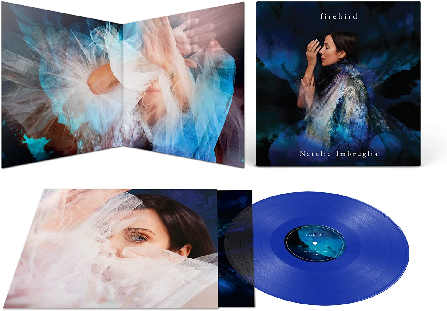 Natalie Imbruglia album cover featuring a woman in a blue dress surrounded by dark blue.