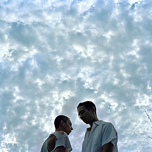 CD cover: two people looking at each other against a cloudy sky.