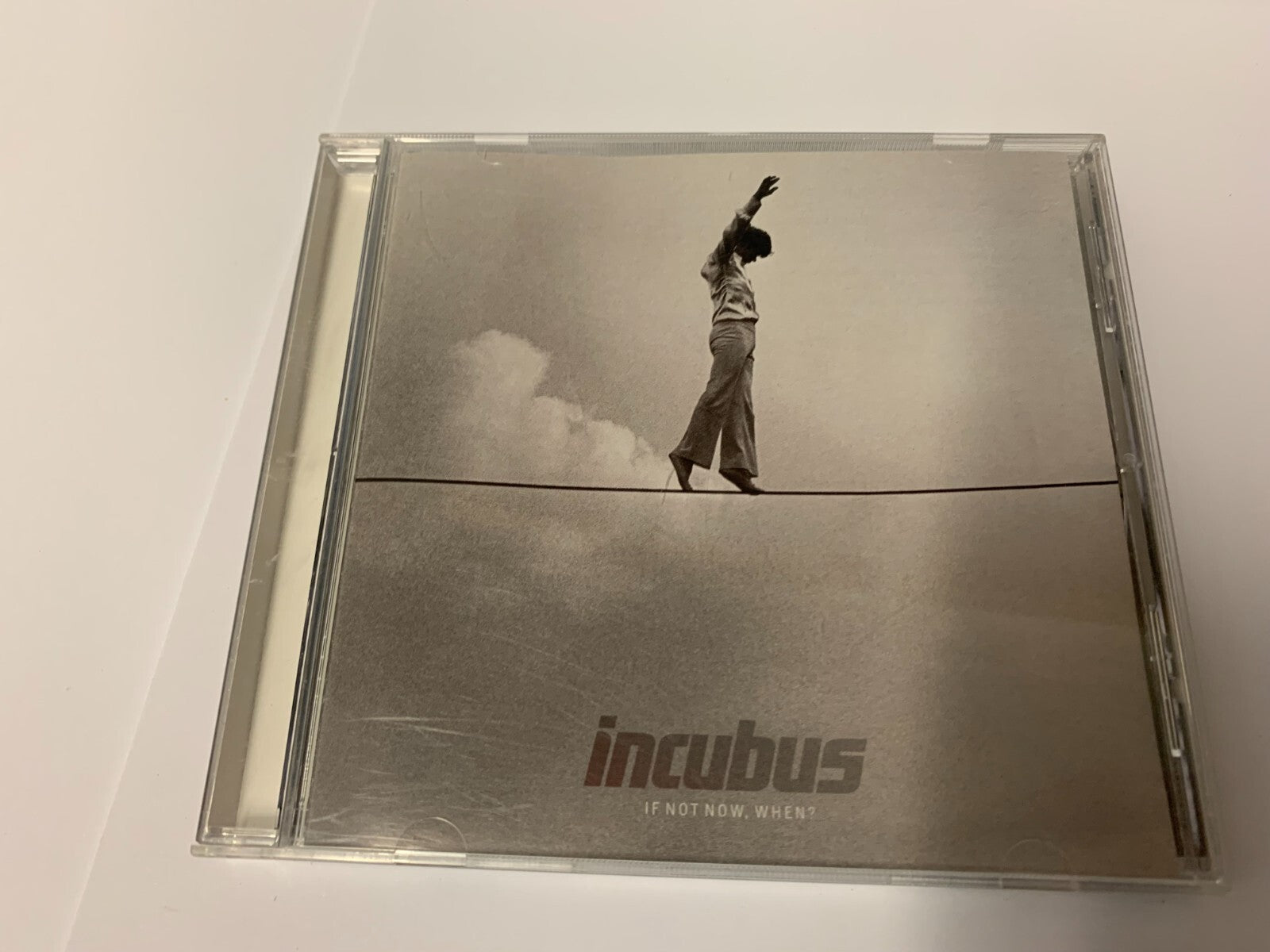 Incubus "If Not Now When" CD case with a man on a tightrope.