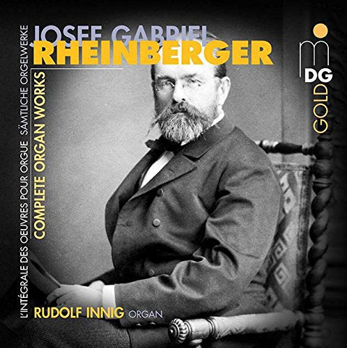 Black and white photo of a man sitting at an organ on a CD cover.