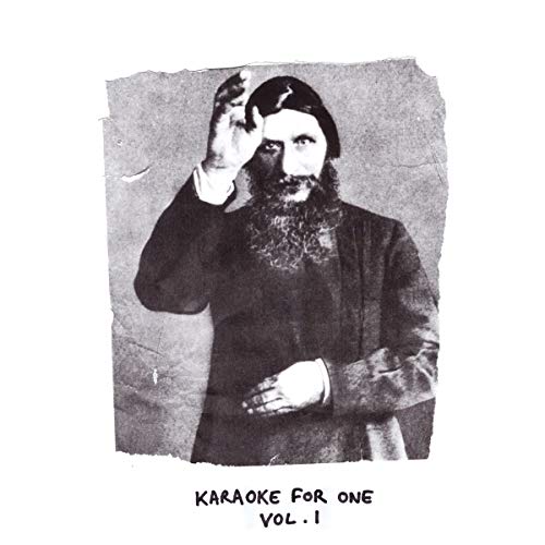 Black and white album cover featuring a bearded man in dark clothing, hand on forehead.