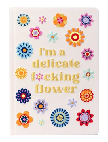 White journal cover with colorful embroidered flowers and bold text.