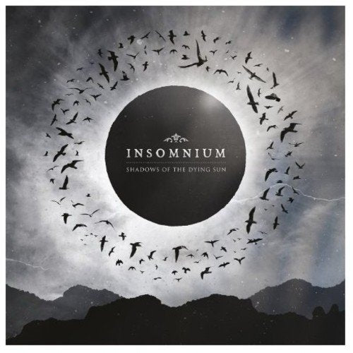 "Album cover with black circle, white text, and birds flying around it."
