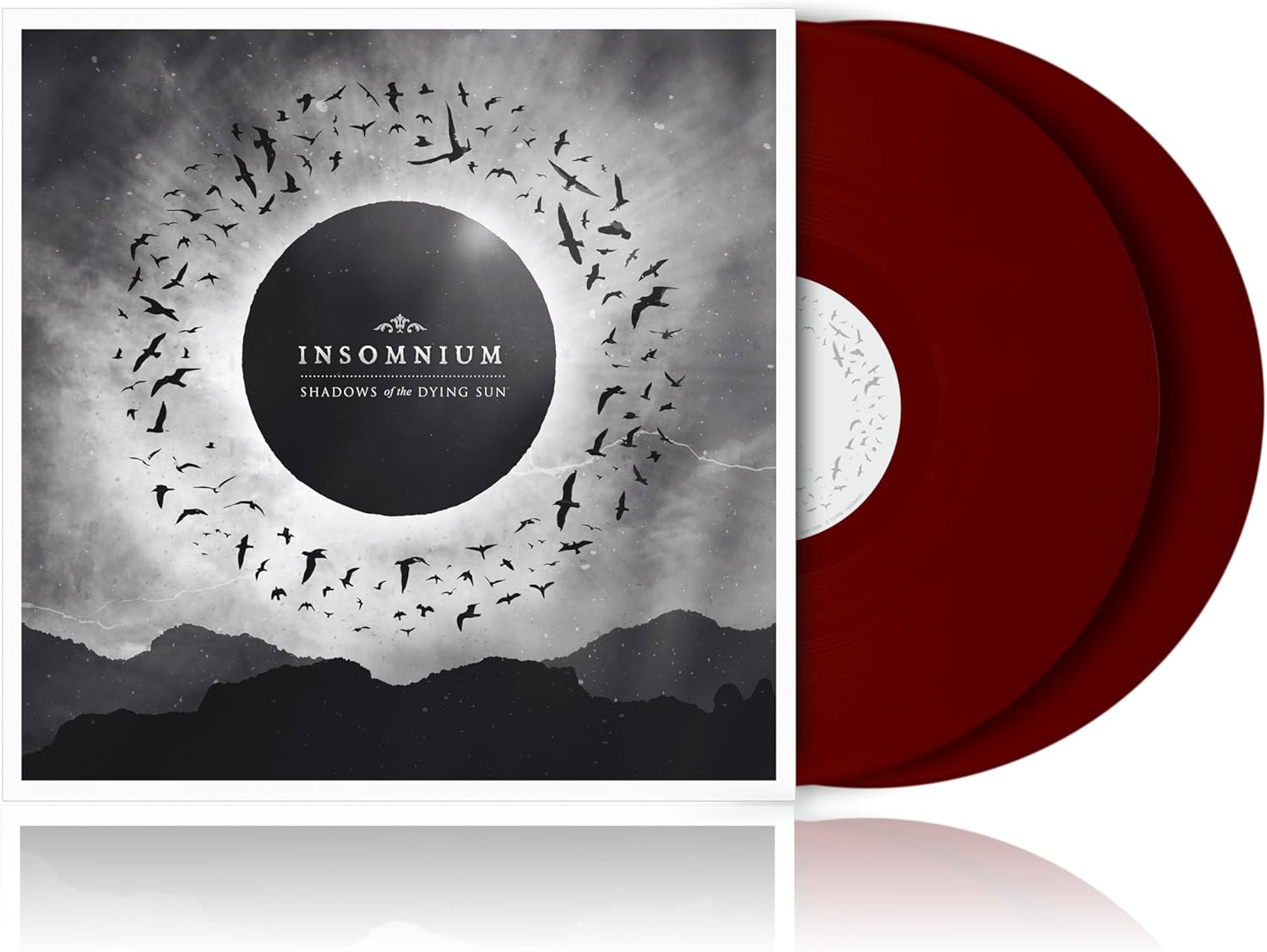 Insomnium album cover with a solar eclipse and red vinyl record.