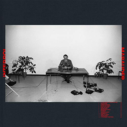 Interpol’s “Marauder” CD cover: man at table with plants, black and white.