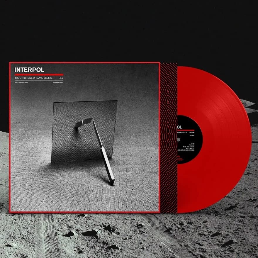 Interpol vinyl record with red disc and album cover featuring a mirror on sand.