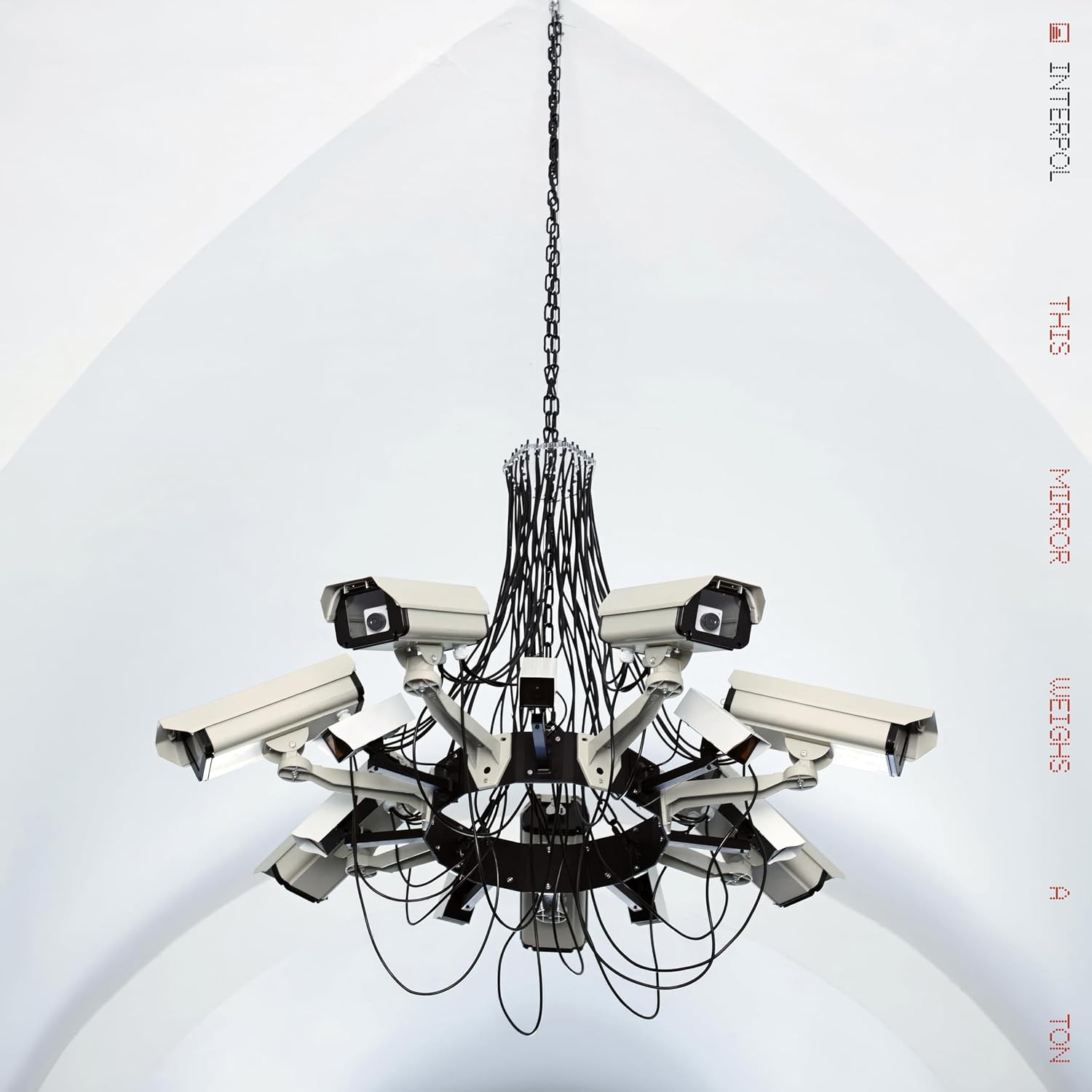 Interpol CD cover featuring a chandelier made of security cameras and a white disc.