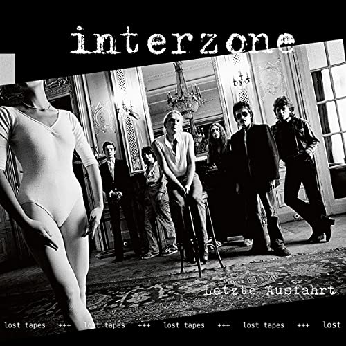 Black and white CD cover featuring a group and a mannequin.