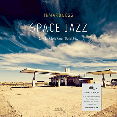 "Album cover with vintage gas station, cloudy sky, and 'Space Jazz' title."