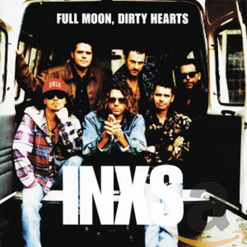 "Album cover featuring the band INXS sitting in the back of a van."