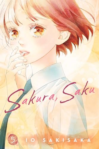 Manga volume with a pink and white cover, featuring illustrated characters.
