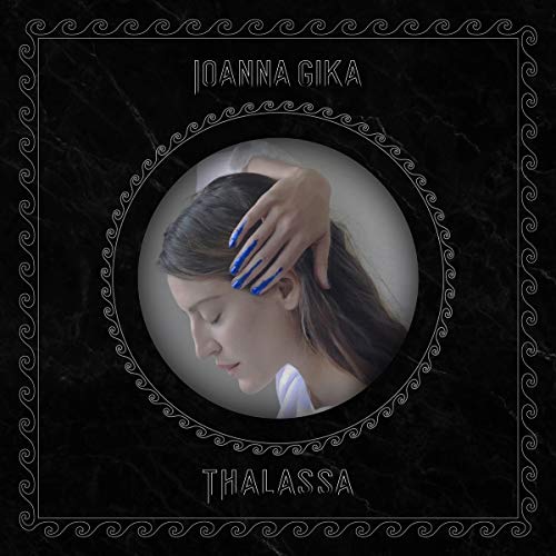 Album cover showing a woman with blue paint on her fingers inside a frame.