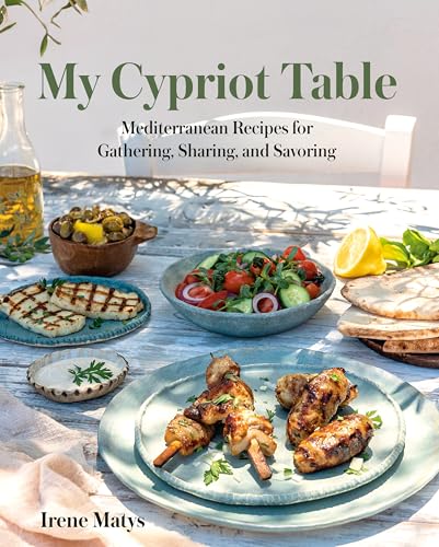 Cookbook cover featuring Mediterranean food on a sunlit wooden table.