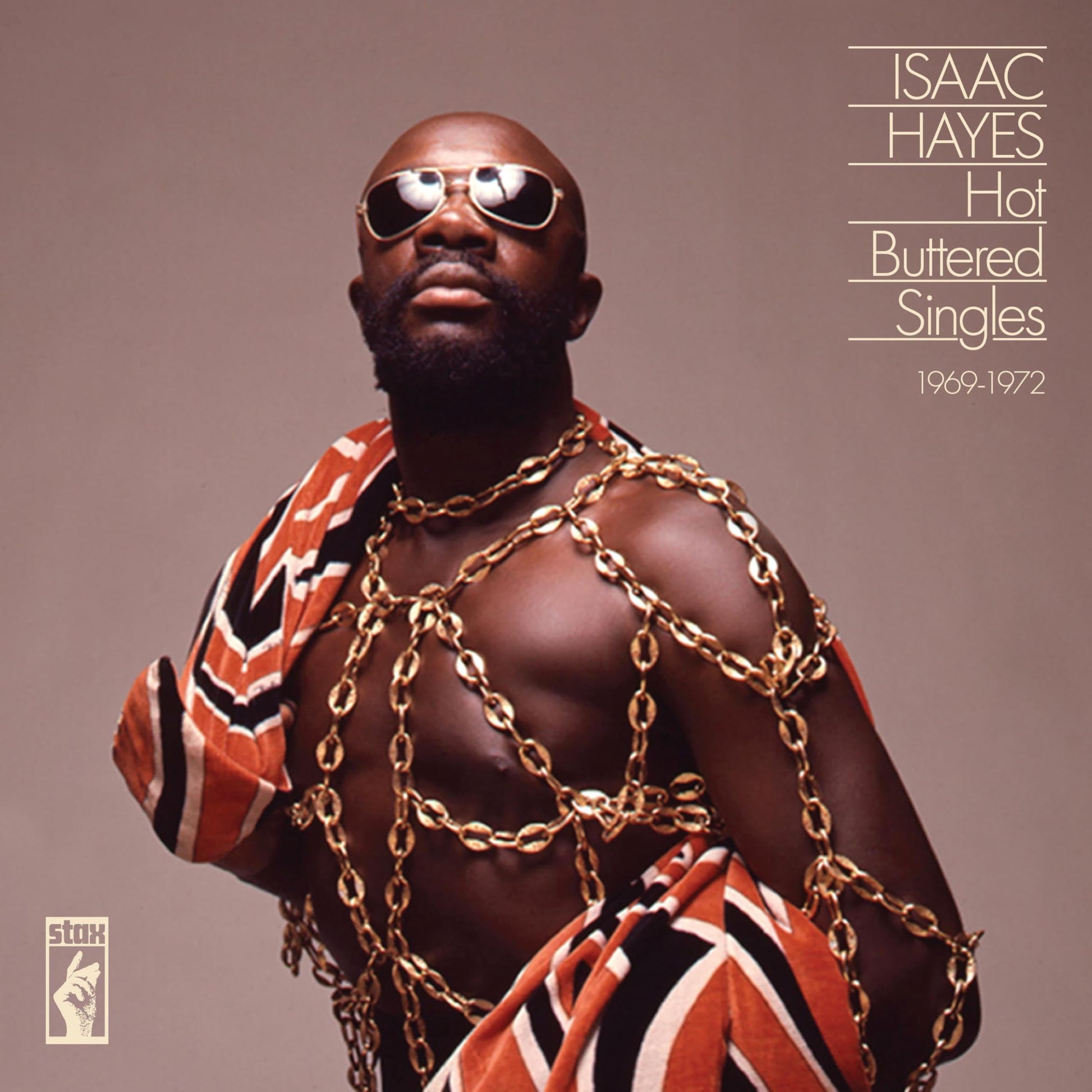 Isaac Hayes wearing sunglasses and gold chains draped over his bare chest and shoulders.