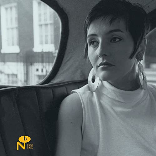 Black and white portrait of Isabelle Antena sitting in a car wearing large earrings.