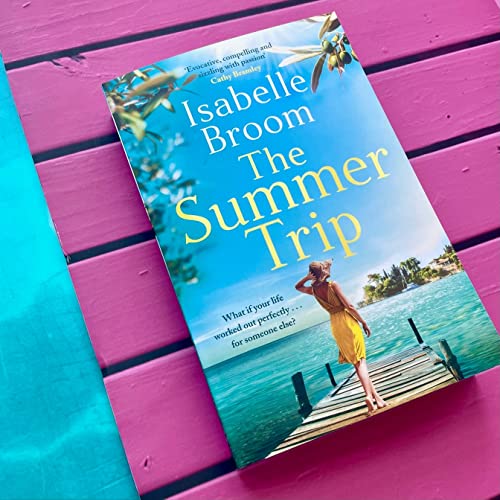 Book cover: "The Summer Trip" with a woman on a wooden pier.