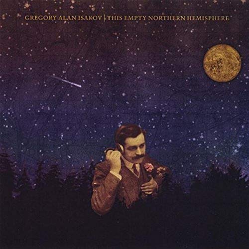 A man in a suit listens to headphones against a starry night sky background.