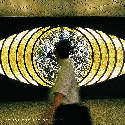 CD cover: blurred figure before a large, illuminated circular structure.