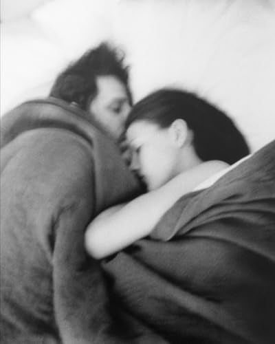 Black and white photo of a couple embracing, heads close together.
