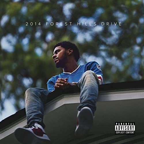 J. Cole album cover, showing him sitting on a rooftop, looking away.