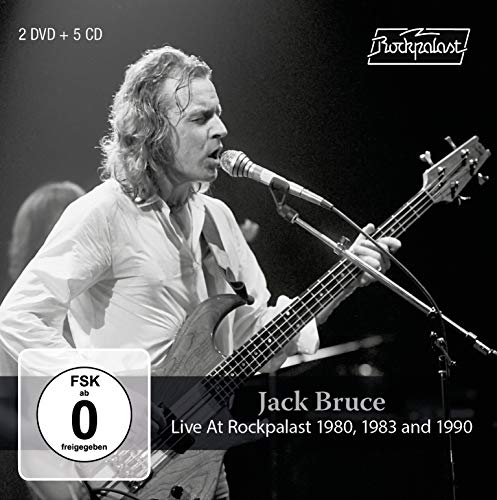 Black and white image of Jack Bruce playing bass and singing into a microphone.