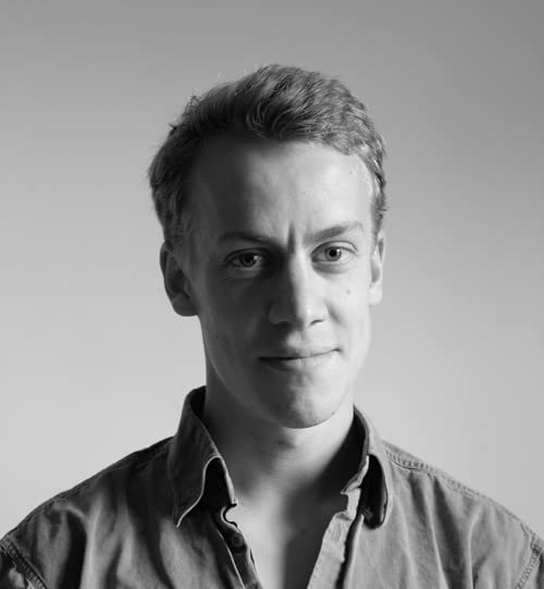 Black and white portrait of a young man with short hair.