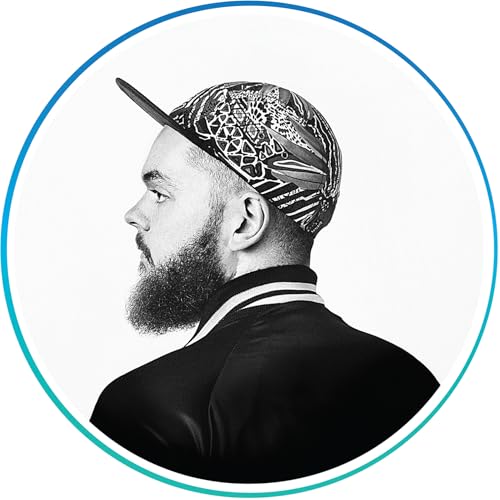 Black and white profile of a bearded man wearing a patterned cap.
