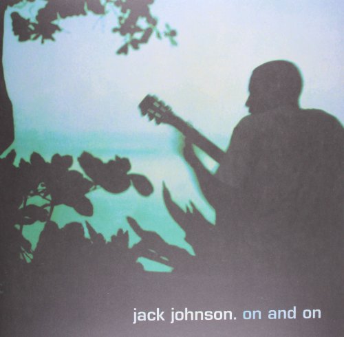 Silhouetted musician with guitar against a teal and dark background.