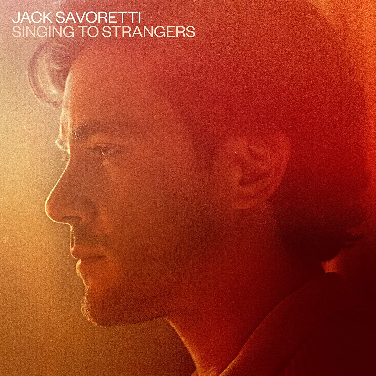 Album cover featuring a close-up of a man's profile in warm, red-toned lighting.