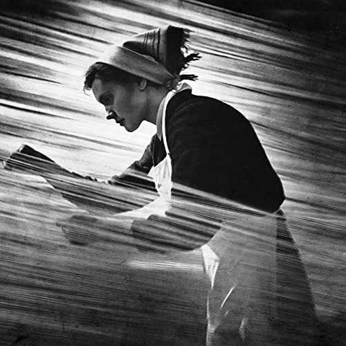 Black and white album cover featuring a blurred, distorted portrait of a man.