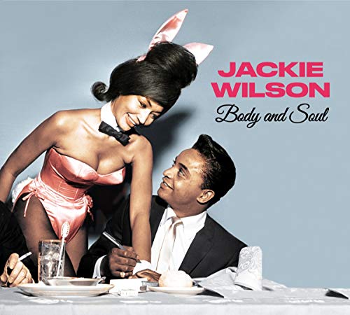 "Album cover with a man and a woman in a playful, flirtatious pose at a table."