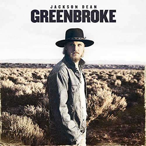Jackson Dean album cover, man in hat standing in dry landscape.
