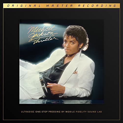 Michael Jackson’s “Thriller” vinyl record cover featuring the artist in white.