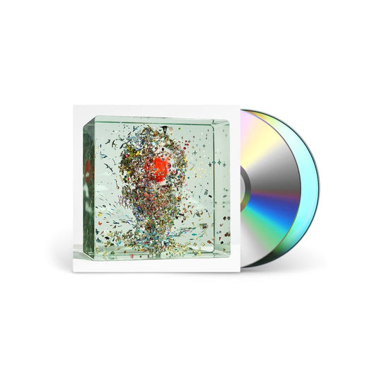 CD album cover featuring a glass cube filled with colorful debris and a disc.
