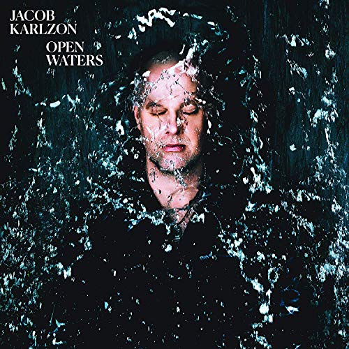 "Man's face obscured by shattered glass, with text 'Jacob Karlzon Open Waters'."