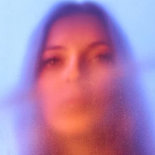 Blurred portrait of a woman with orange and blue tones.