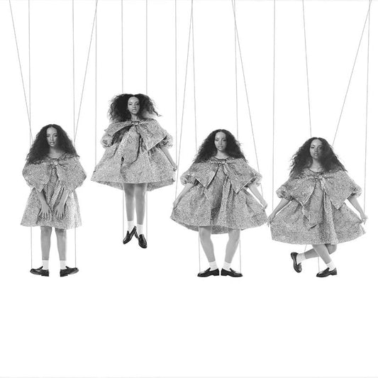 Black and white image of Jade as four puppet-like figures in dresses.