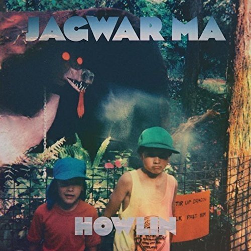"Album cover featuring two boys and a menacing bear in a jungle."