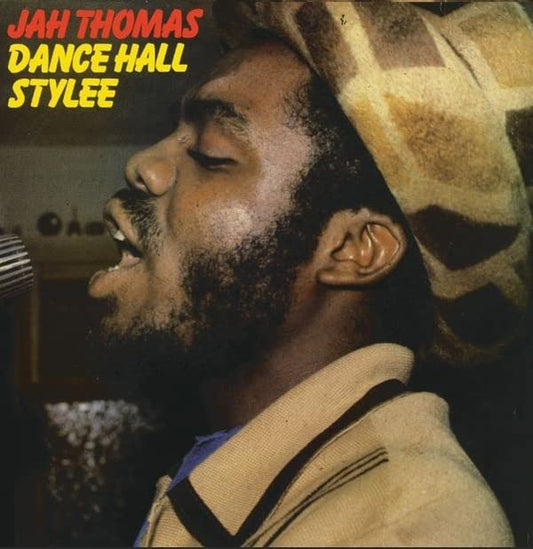 Vinyl record cover featuring Jah Thomas with dreadlocks, singing into a microphone.