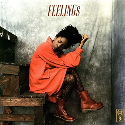 Jah9 album cover: woman in red, seated on weathered wood steps.