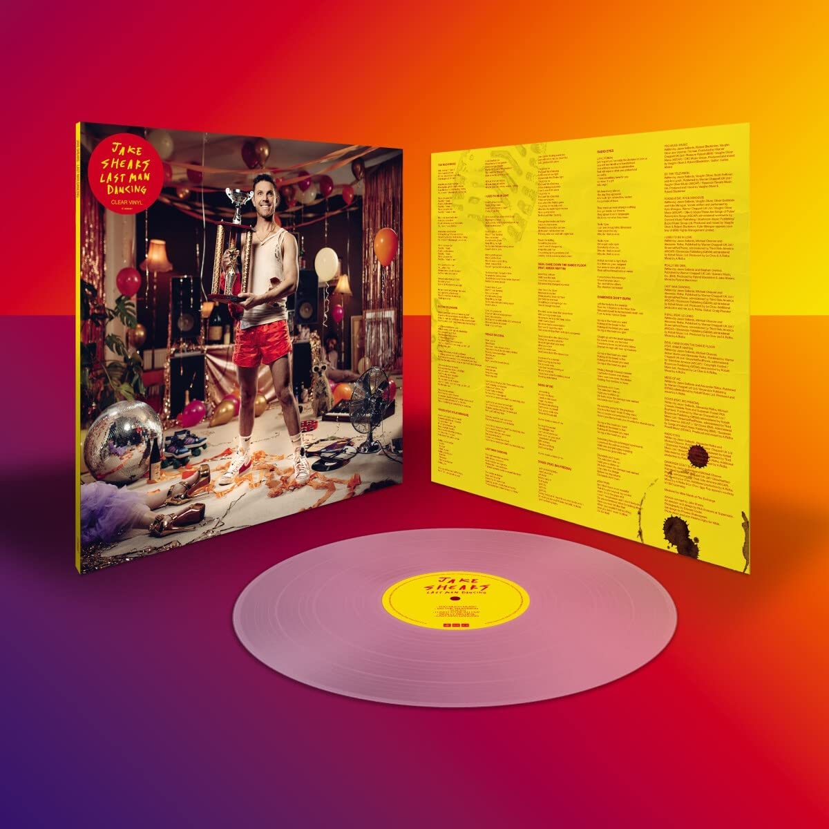 "Clear vinyl record with album cover and yellow insert, gradient background."