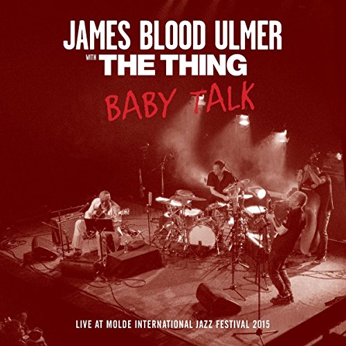 "CD cover featuring a red-toned photo of a band performing on stage."