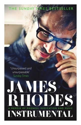 Book cover featuring a man with glasses holding a small wooden instrument.