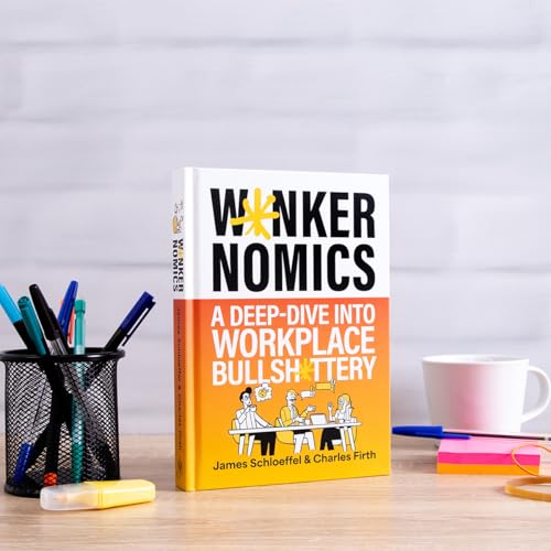 Book cover, "Wankernomics," with pens, a mug, and notepad nearby.